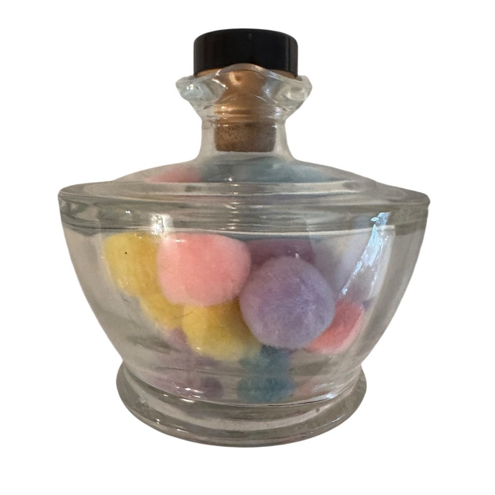 Glass corked jar filled with pastel colored pompom balls home accent decor